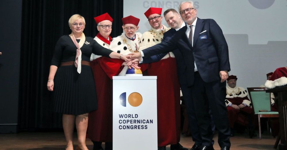 Picture presents 6 people: 5 men and 1 women who are pressing button to signify the beginning of the Congress