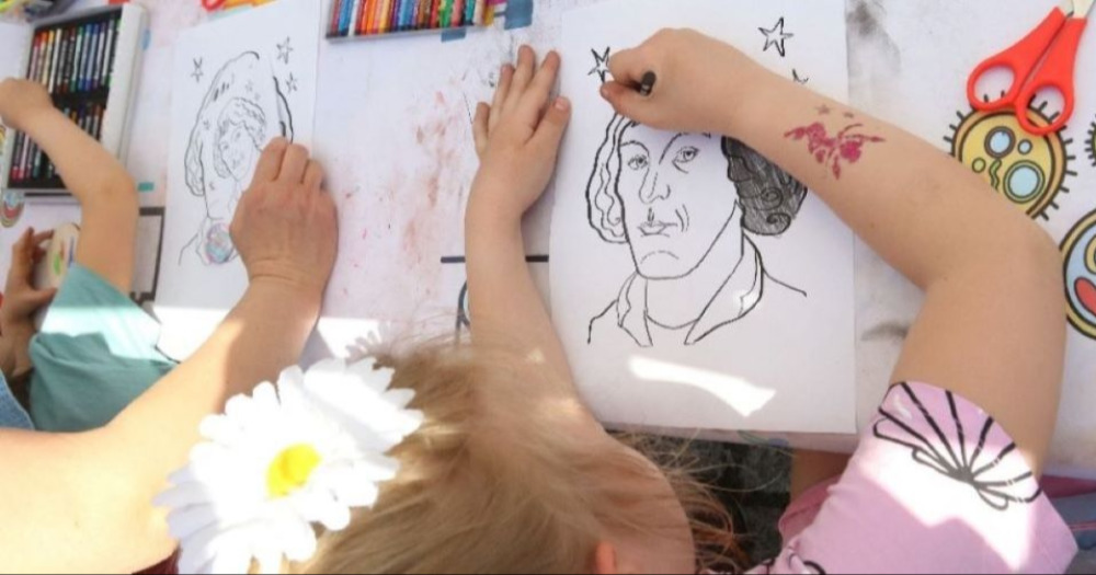 Photo of children coloring coloring pages with the image of Nicolaus Copernicus.