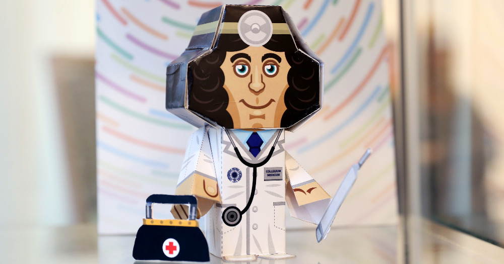 Photo of paper figurine of Nicolaus Copernicus as a doctor (in a doctor's coat, with a stethoscope)